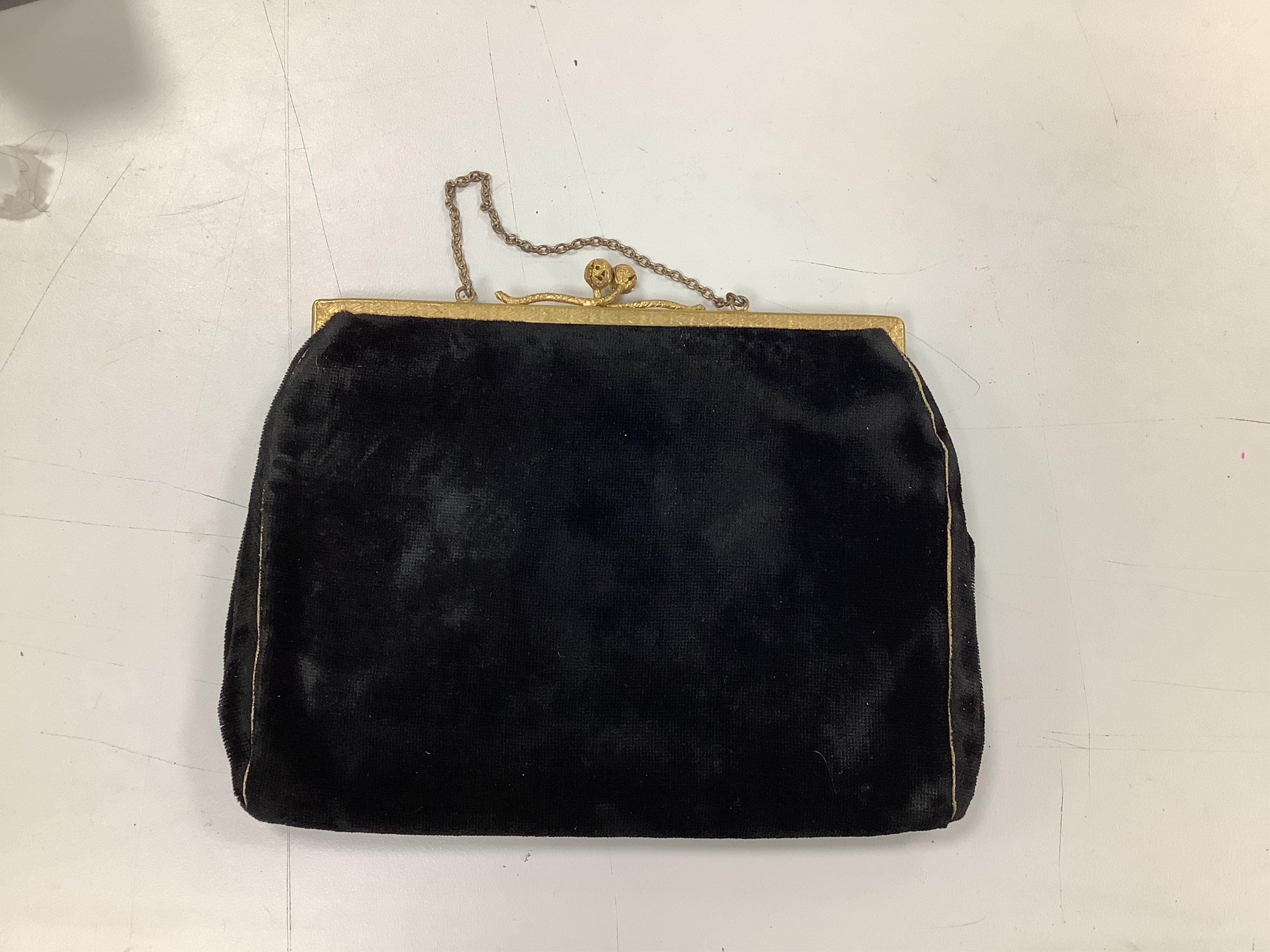 A 1940’s black velvet gold and silver embroidered evening clutch bag and an earlier 1930’s bead worked evening bag and an another black velvet bag,1940’s clutch bag 21cm wide. Condition - black bag good, white bead bag i